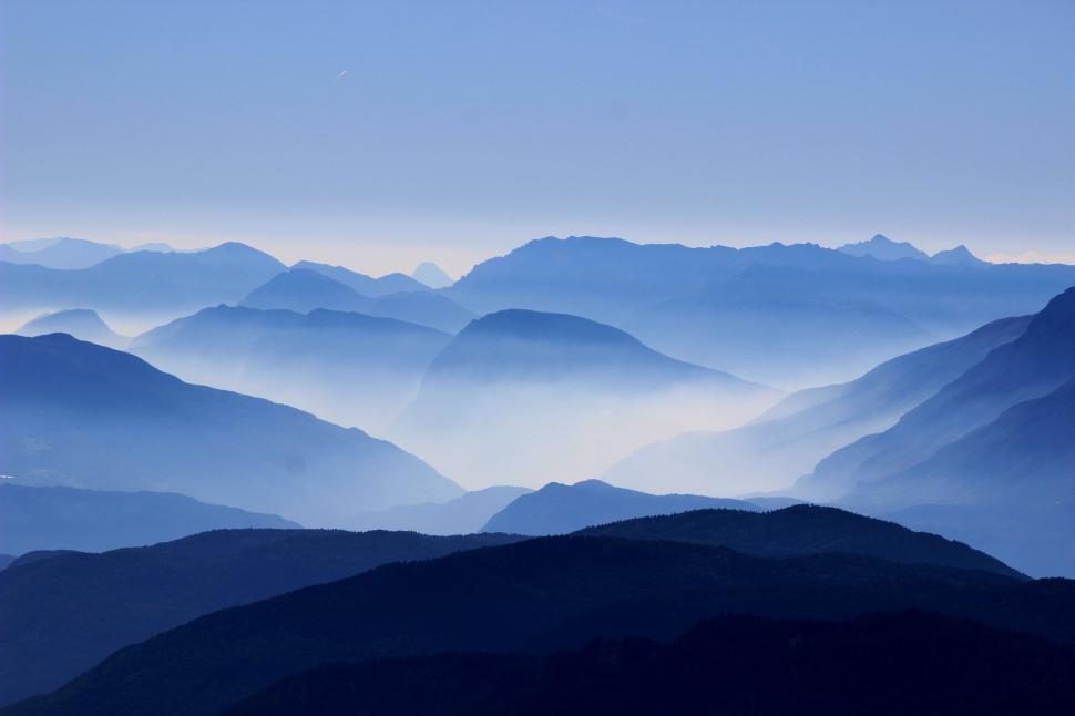 Free Image of Foggy blue mountain ranges with layers of misty low clouds 