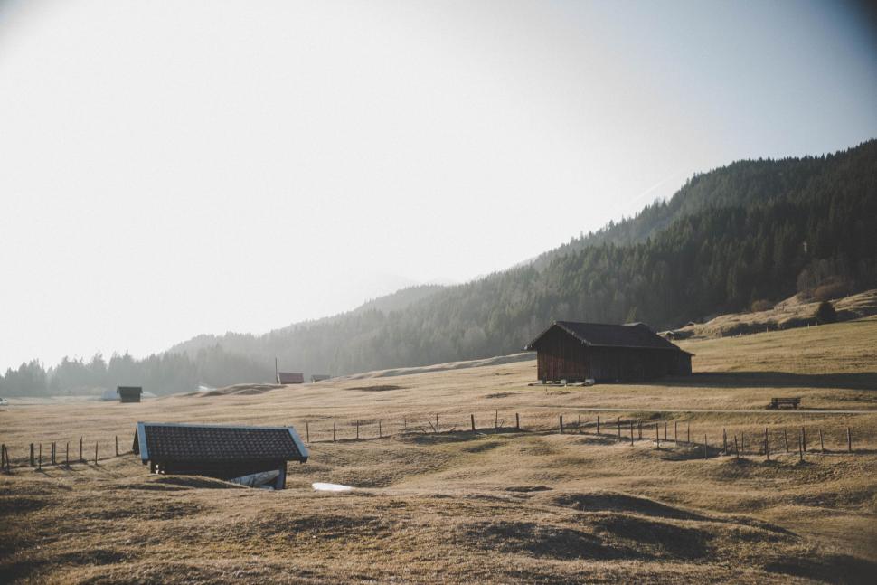 Free Image of Scenic view of rural landscape with hills and barns and fences 