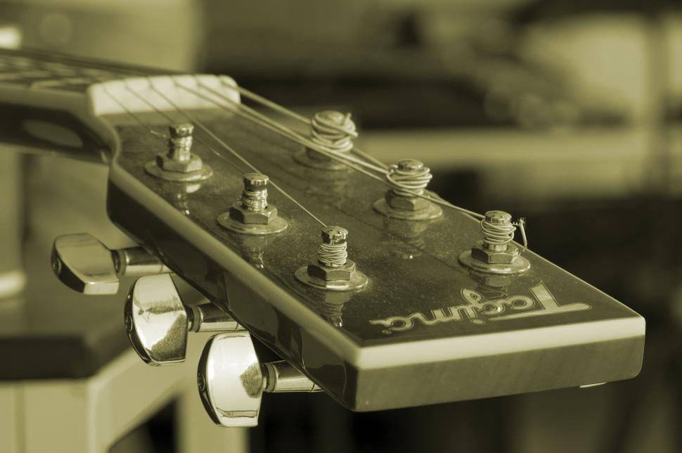 Free Image of Close-up of a guitar headstock with focus on tuning pegs 