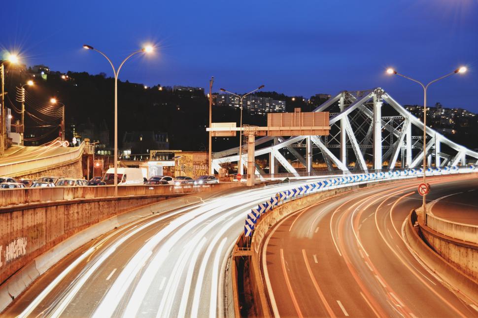 Free Image of Light trails on a busy highway captured during early evening. 