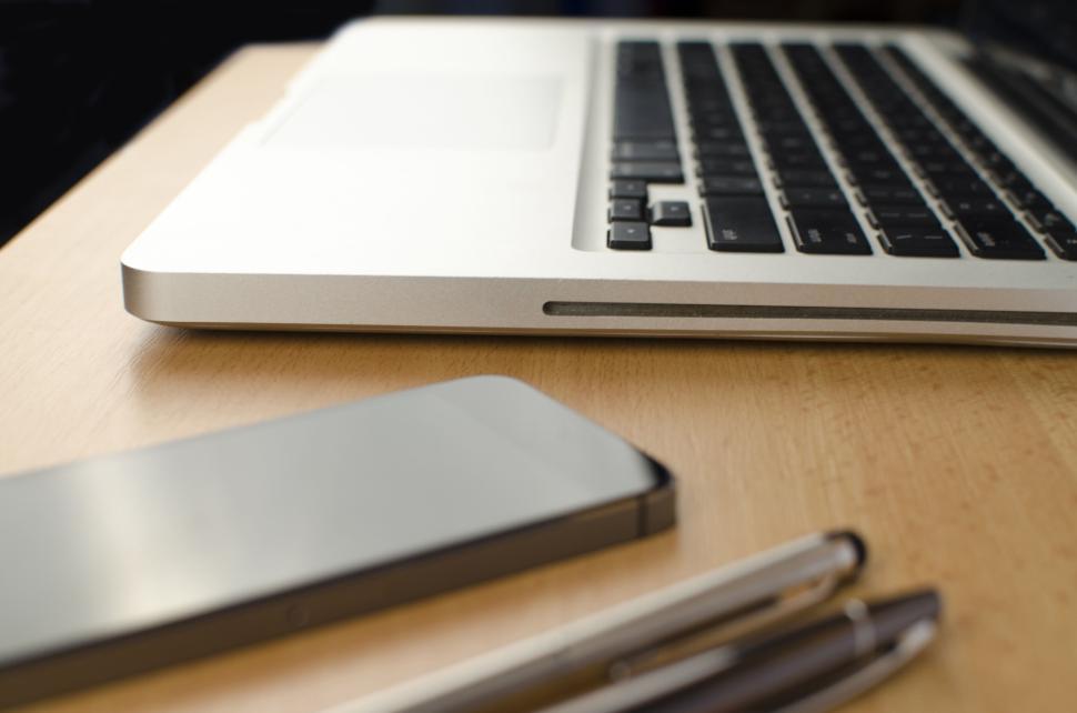 Free Image of Modern laptop and smartphone on wooden desk with pens 