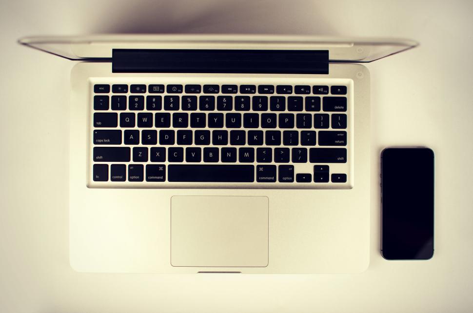 Free Image of Top view of a laptop and a smartphone on a minimalist workspace 