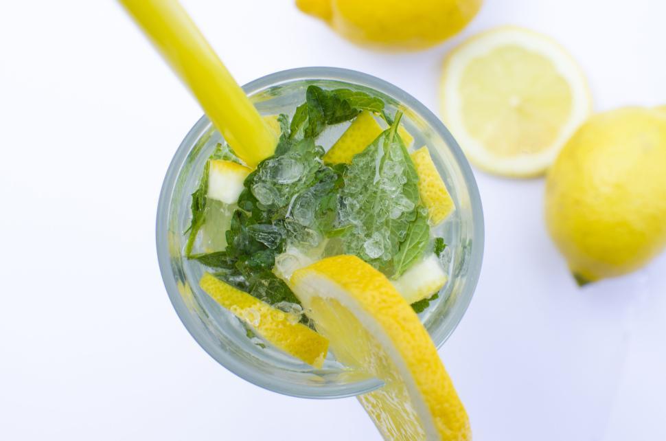 Free Image of Glass of fresh lemonade with mint leaves and lemon slices inside. 