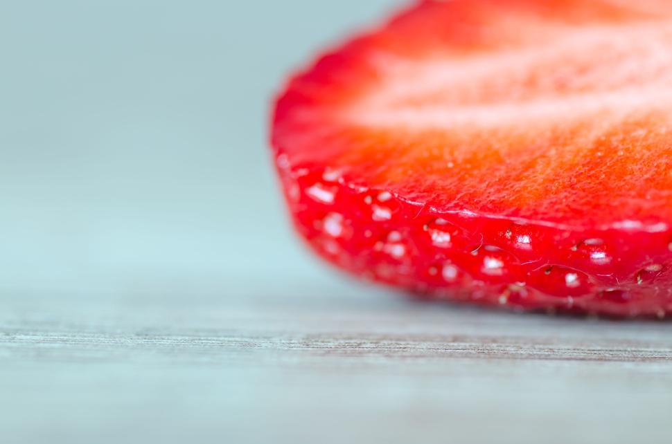 Free Image of Close-up macro shot of a fresh and juicy slice of strawberry 