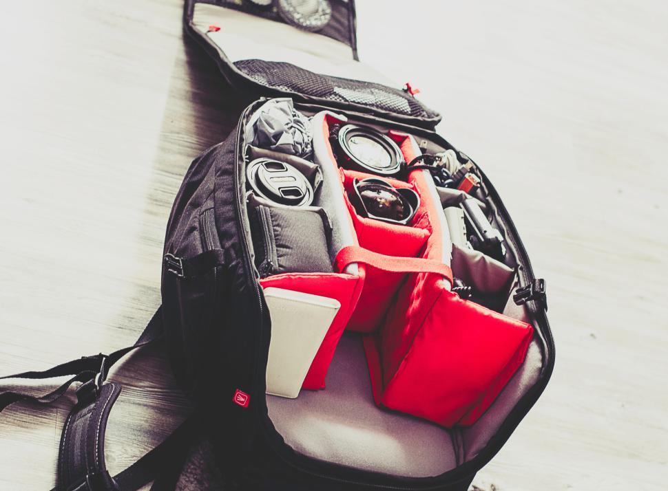 Free Image of Camera backpack with compartments and gear organized inside 