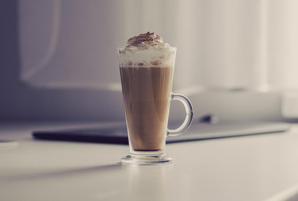 Free Image of Tall glass of latte with whipped cream in cozy coffee shop 