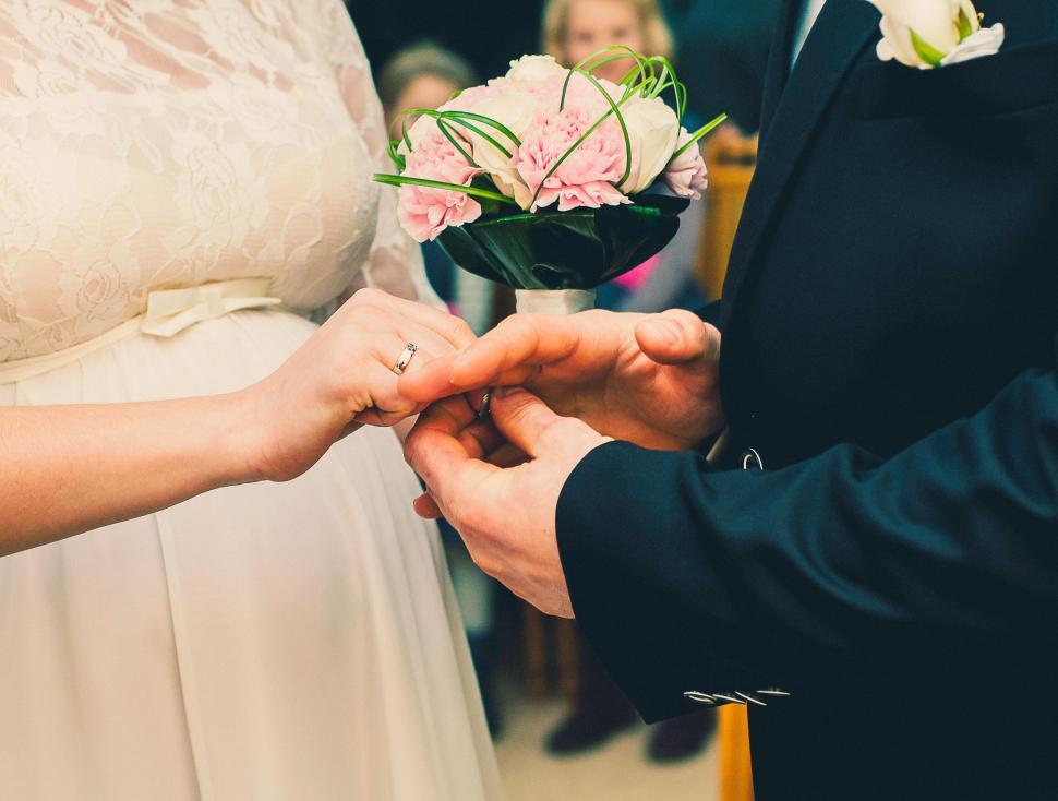 Free Image of Bride and groom exchange rings during their wedding ceremony 