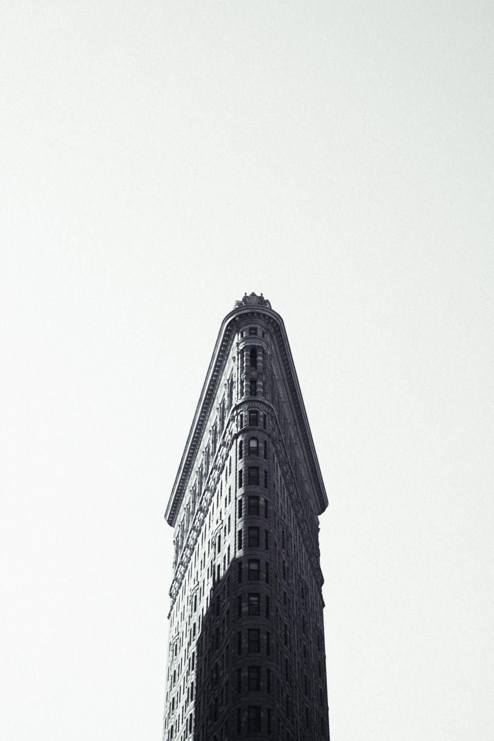 Free Image of Iconic skyscraper with triangular facade against a bright sky background. 
