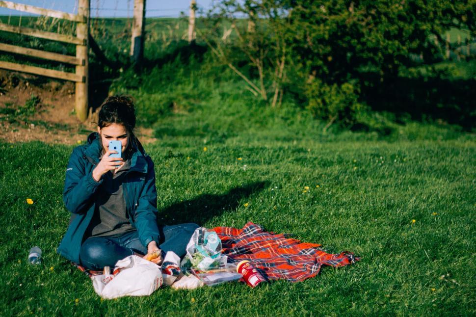 Free Image of Person enjoying a picnic in a park with outdoor essentials around 
