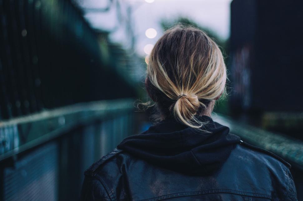 Free Image of Rear view of person with ponytail walking through an urban area. 