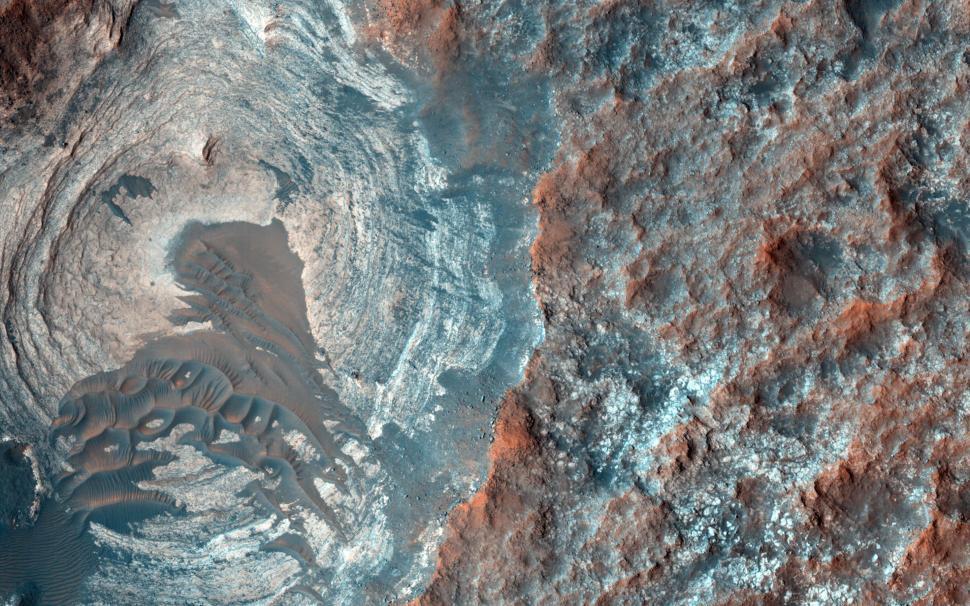 Free Image of High-resolution view of Martian surface showing crater and landscape. 