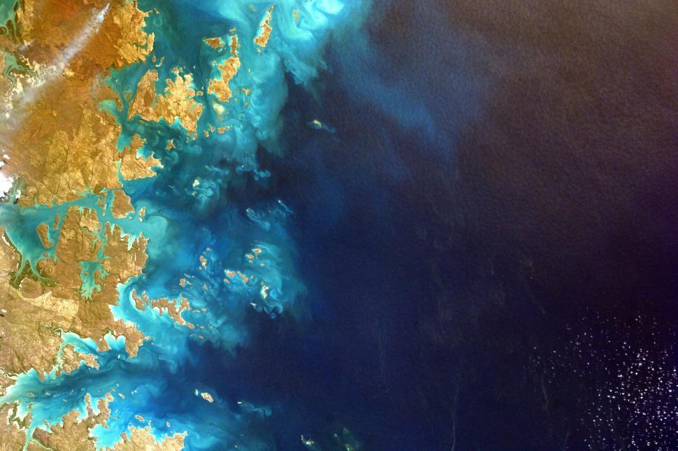 Free Image of Vivid aerial view of coastal landscape with turquoise waters and land. 