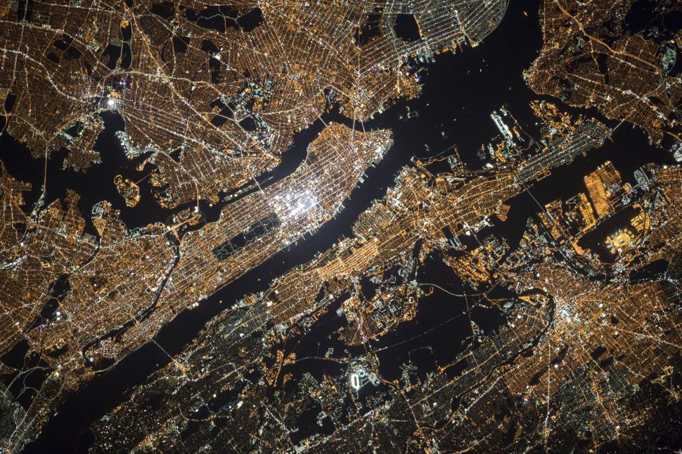 Free Image of Night aerial view of illuminated cityscape showcasing urban lights. 