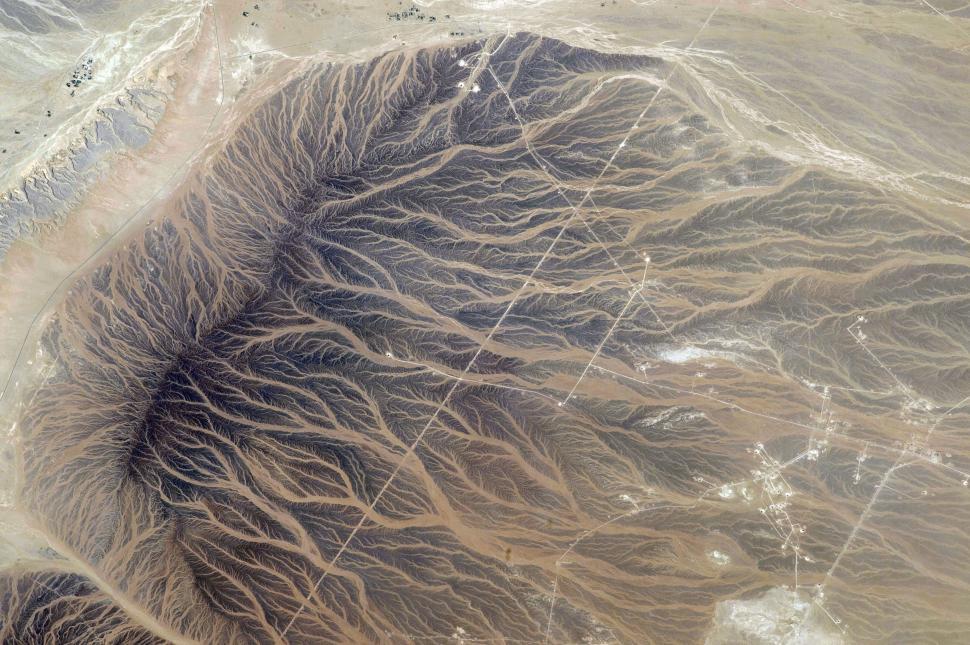 Free Image of Aerial perspective of desert terrain with intricate patterns of erosion. 