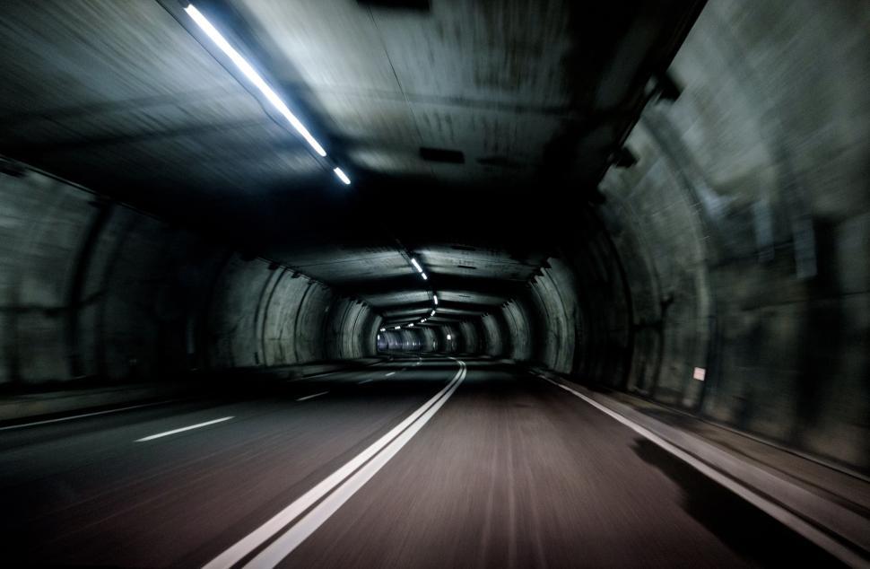 Free Image of Dimly lit tunnel creates an illusion of infinite road and darkness 