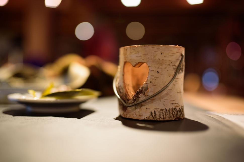 Free Image of A decorative birch candle holder with a heart cutout sits on display. 