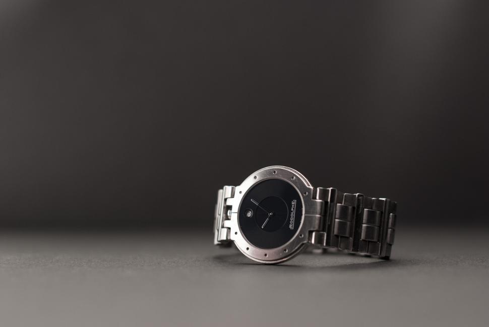 Free Image of Close-up of a sleek wristwatch with metal strap on a neutral background 