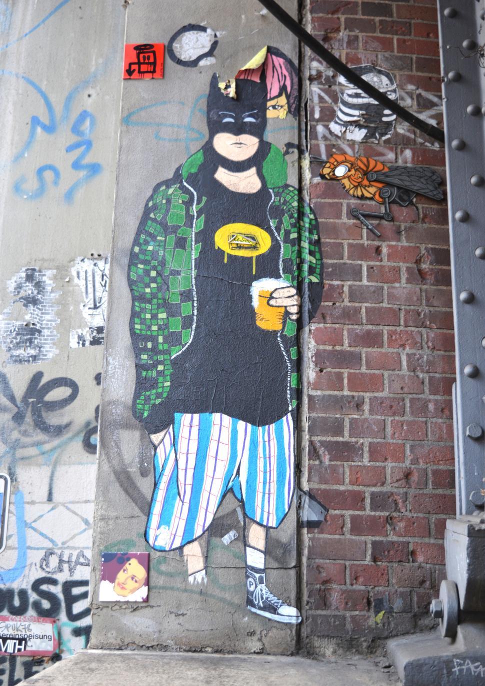 Free Image of Colorful street mural of a figure in casual clothes with urban graffiti 