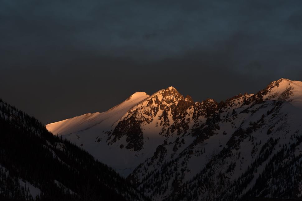 Free Image of Snow-capped mountains glowing under morning sunlight 