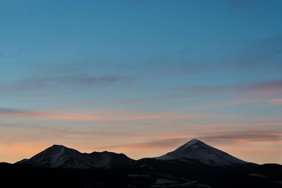 Free Image of Two snow-capped mountains at dawn with colorful sky 