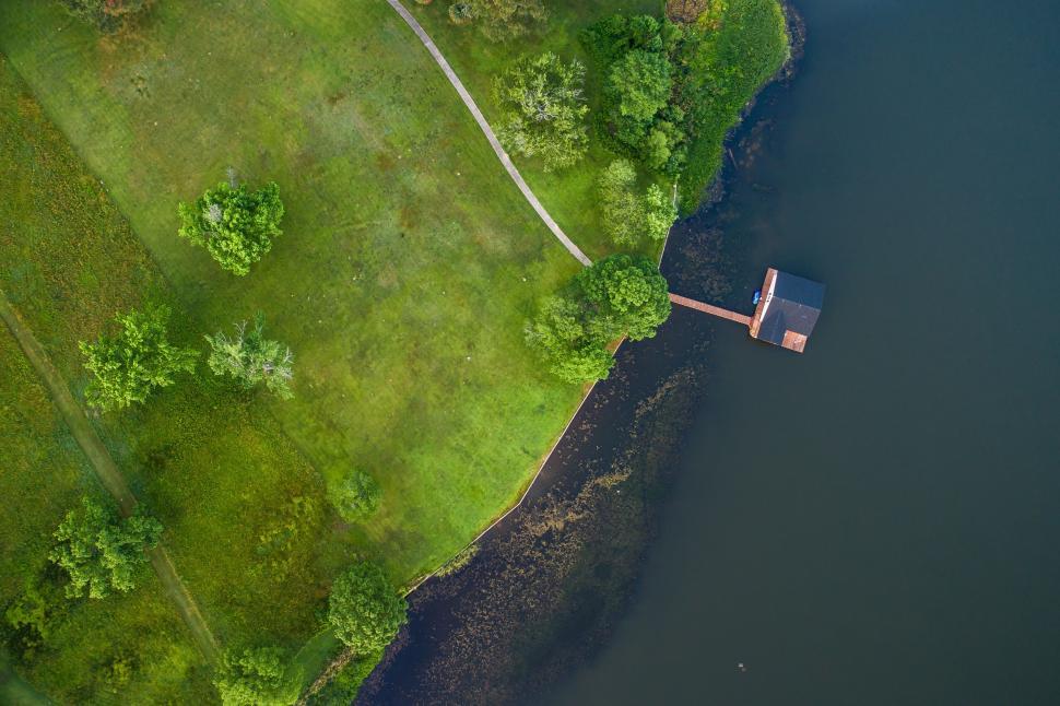 Free Image of Lakeside view with a solitary house over calm water. 
