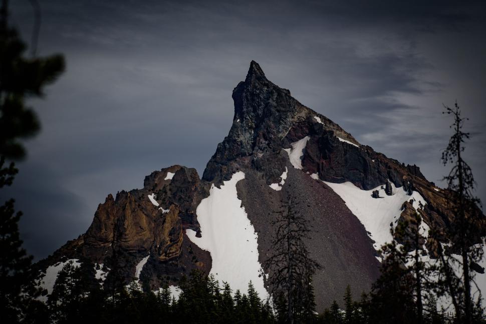 Free Image of Sharp rugged mountain peak with snow and rocks 