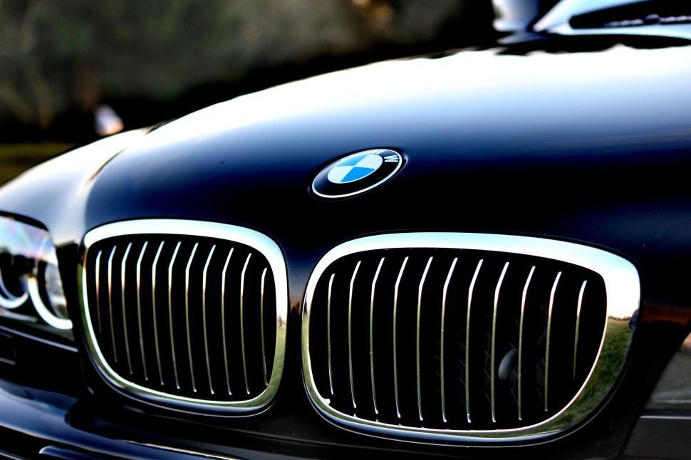 Free Image of Close-up of a luxury car grill showcasing BMW logo and chrome details 