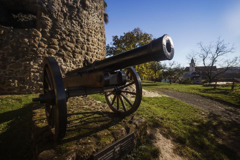 Free Image of Historic cannon displayed outside against a blue sky backdrop 