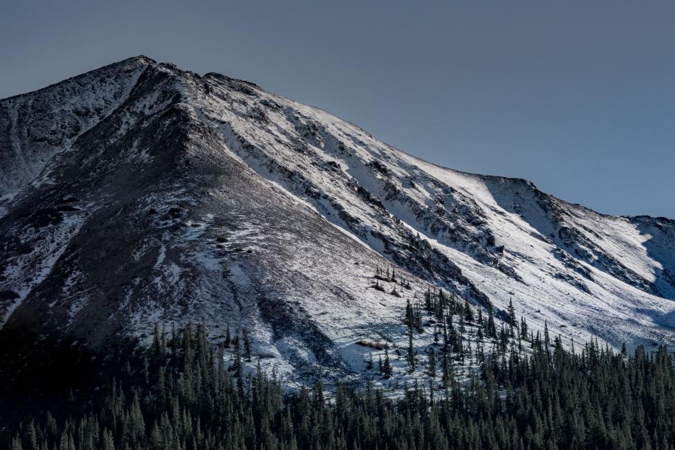Free Image of Snow-capped mountain peak under clear blue sky 