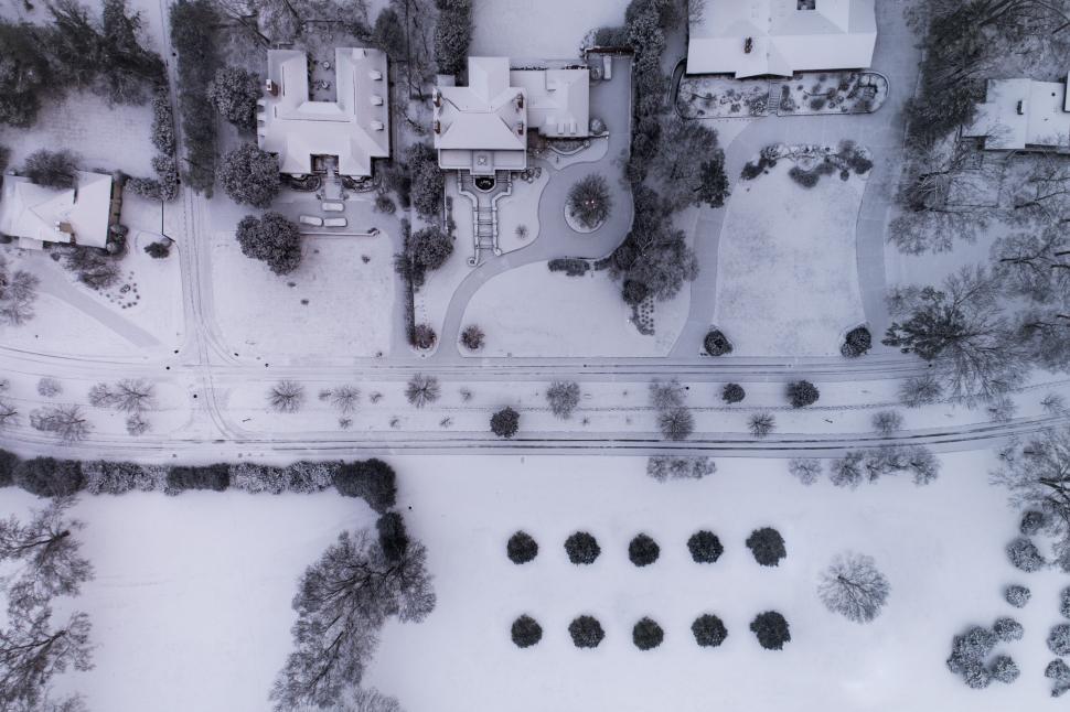 Free Image of Aerial view of suburban neighborhood blanketed in snow. 