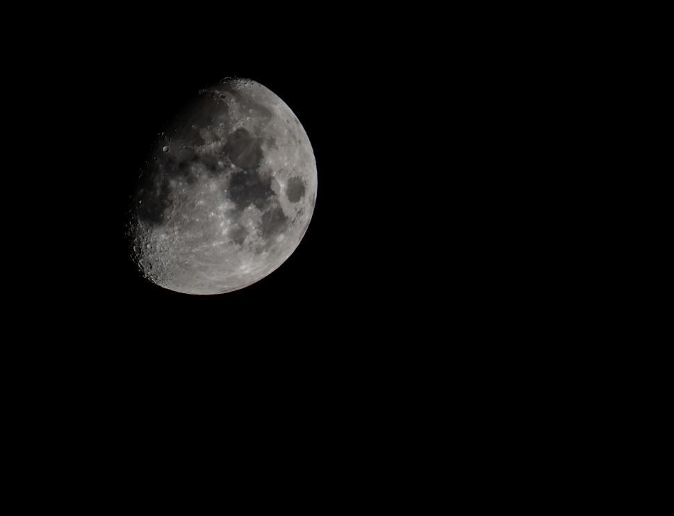 Free Image of Crescent moon in a clear night sky with visible details. 