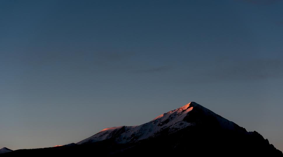 Free Image of Mountains with sunlit peaks during dawn, serene landscape. 