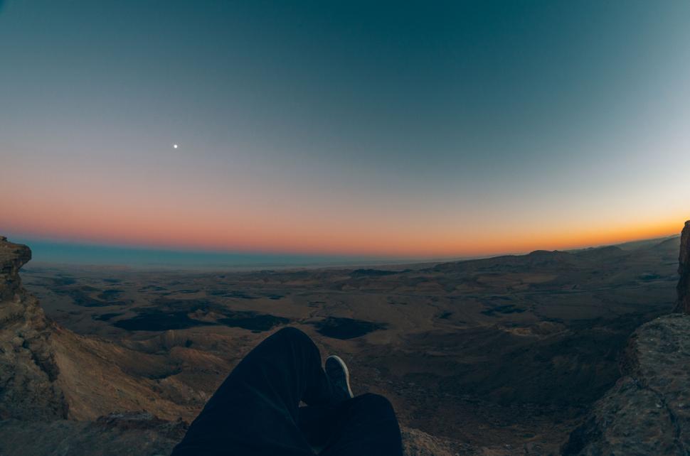 Free Image of Person relaxing while watching a stunning sunset view 