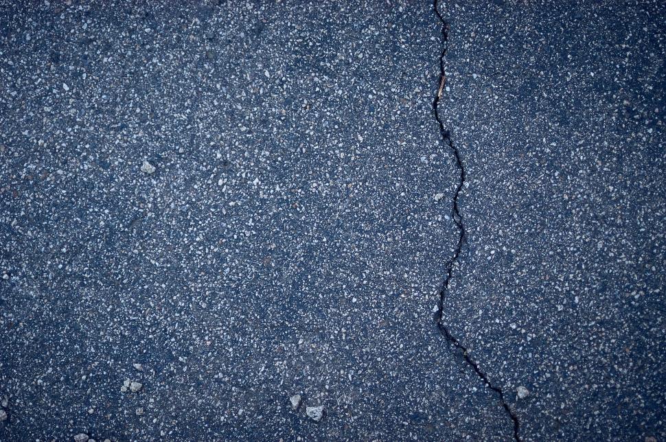 Free Image of Surface of asphalt road with a visible crack in it 