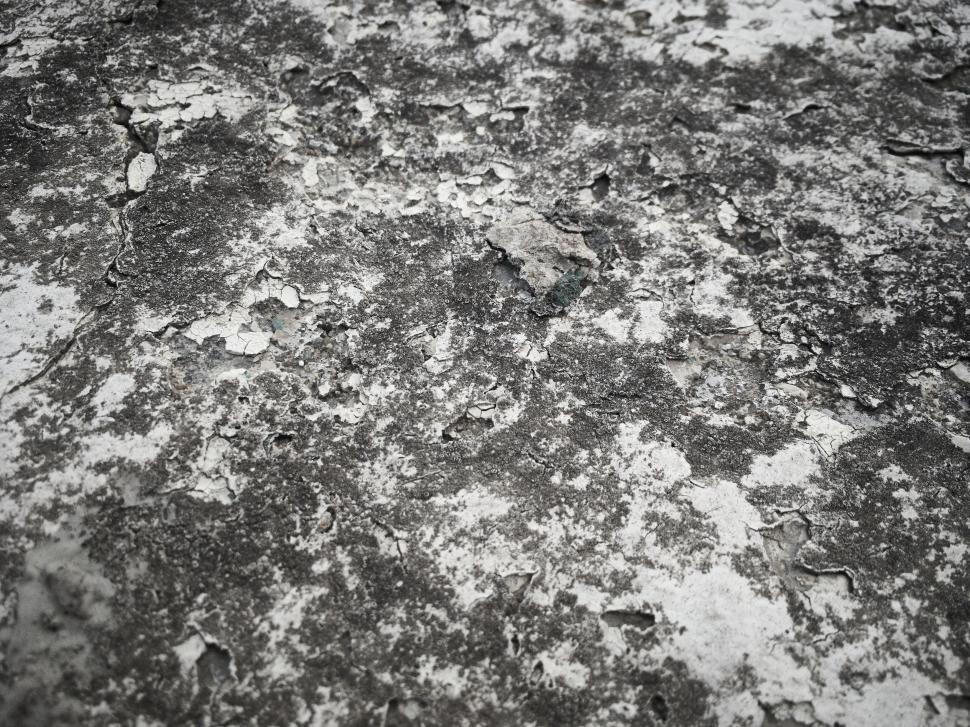 Free Image of Rough and weathered textured gray surface with cracks 