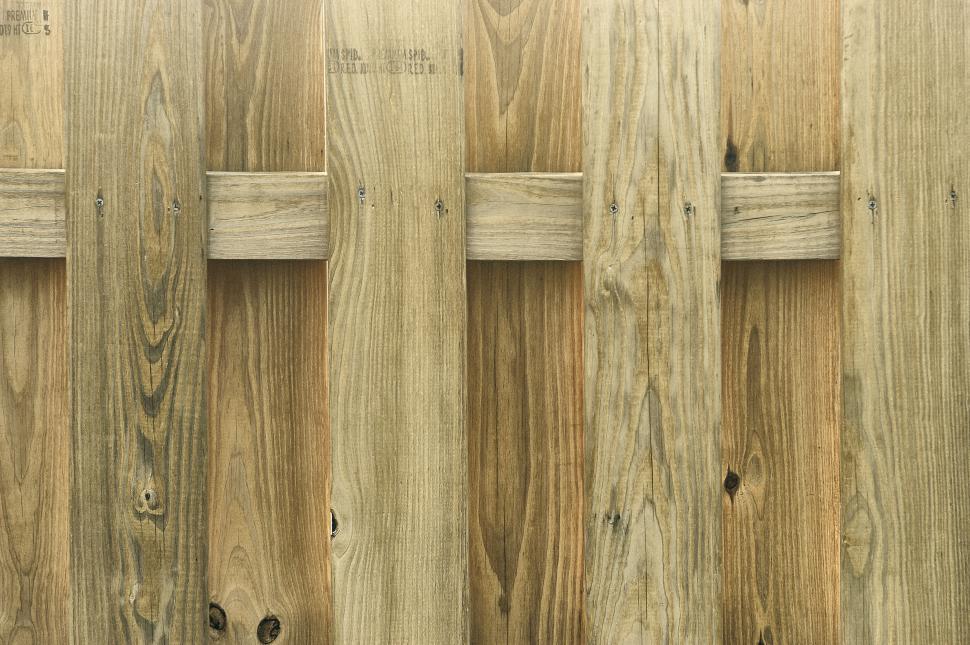 Free Image of Wooden fence with vertical planks and horizontal supports. 