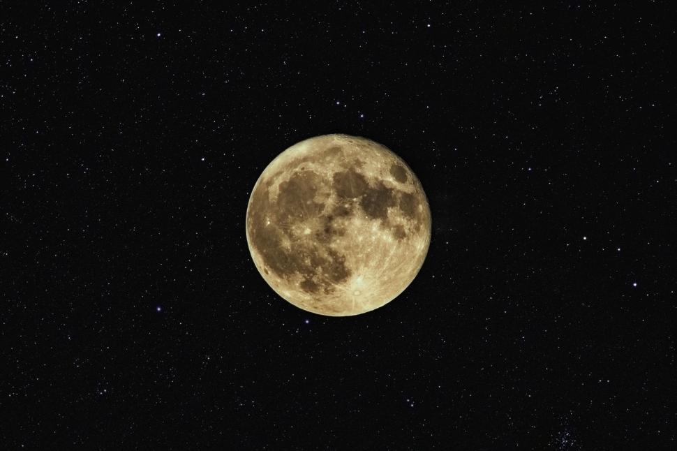 Free Image of Full moon in dark star-filled night sky 