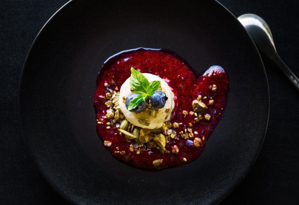 Free Image of Elegant dessert with berry sauce and fresh garnish 