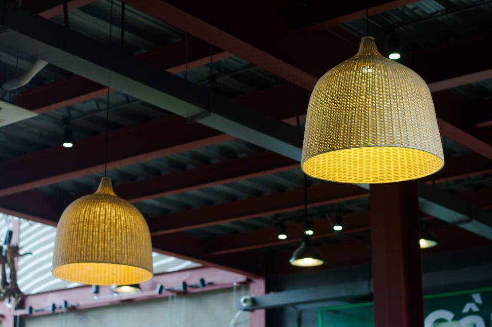 Free Image of Hanging wicker lampshades with warm light indoors 