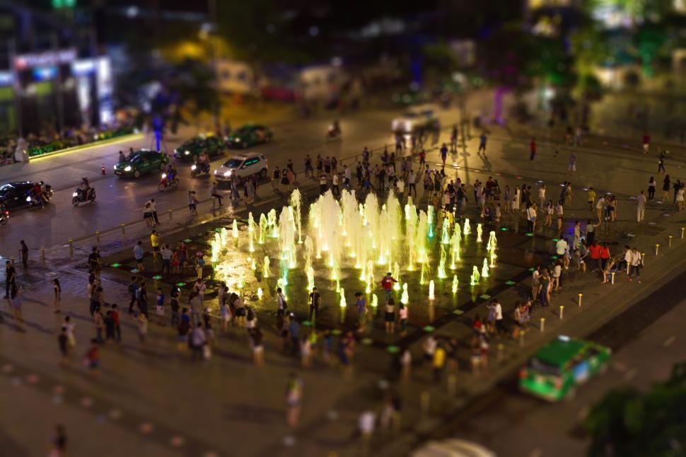 Free Image of Crowded night scene with illuminated fountains in city 