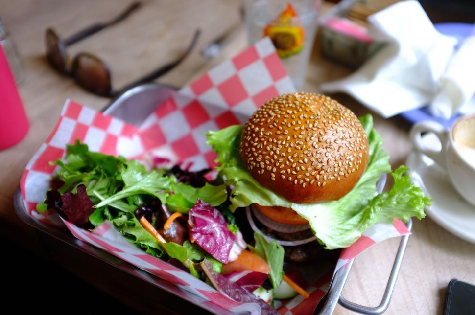 Free Image of Delicious burger with vibrant salad leaves on a tray 