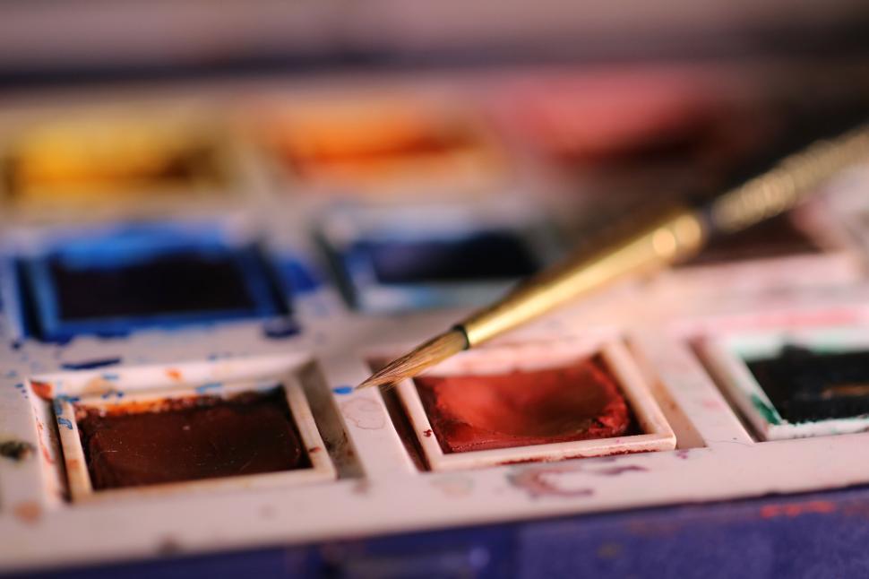 Free Image of Close-up of watercolor paint palette with paintbrush 