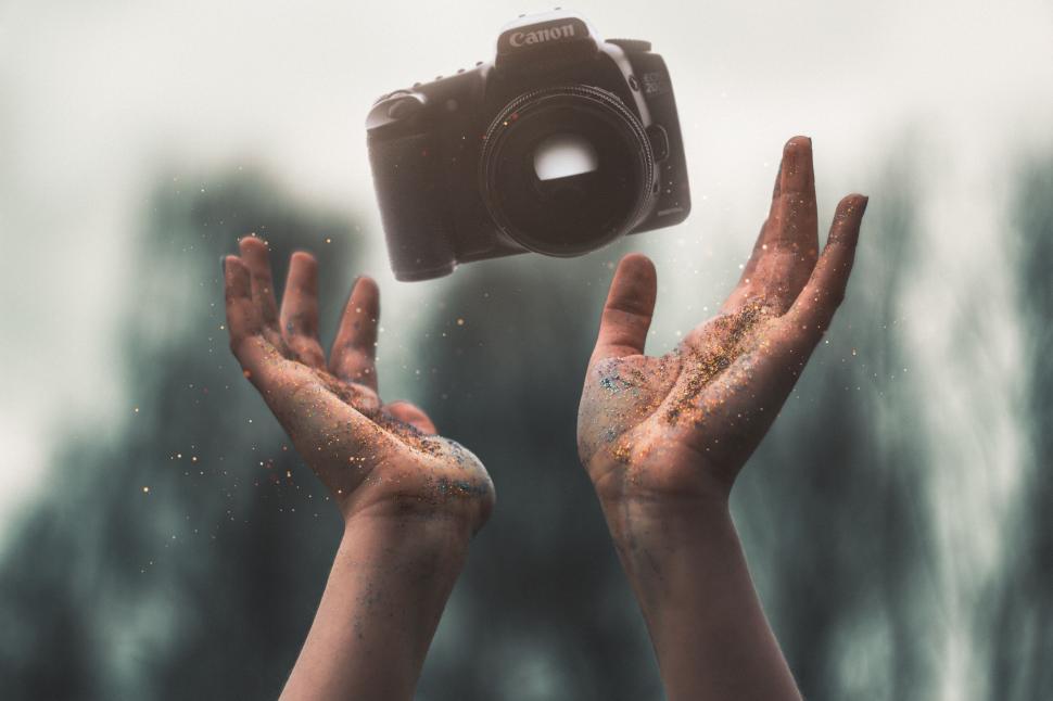 Free Image of Floating camera above hands creating a magical effect. 