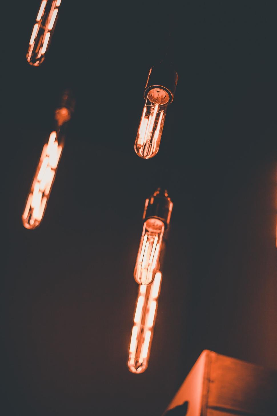 Free Image of Vintage-style hanging light bulbs with warm glow. 