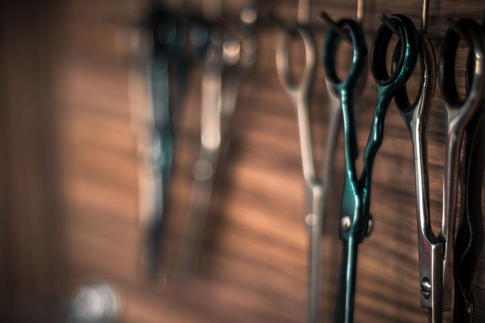 Free Image of Scissors hanging on a wooden wall in a barbershop. 