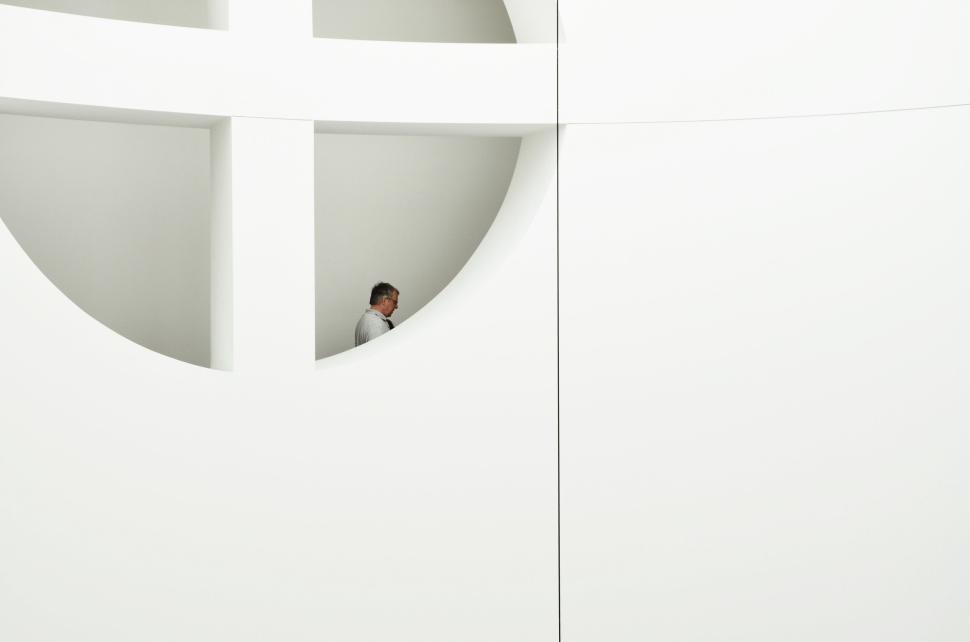 Free Image of A person captured in a minimalistic white setting. 