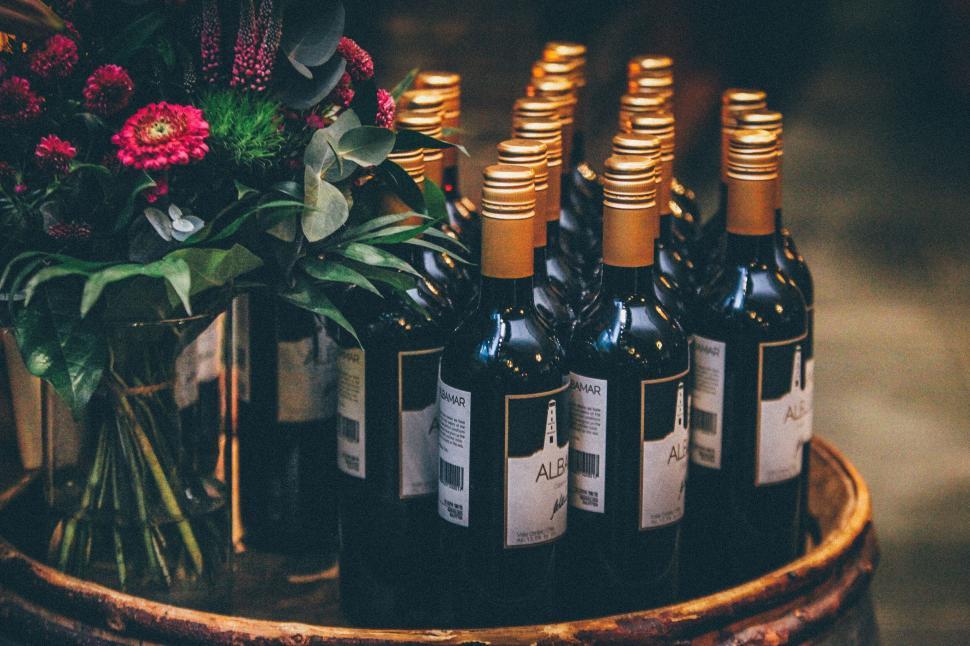Free Image of Wine Bottles on Display With Flowers as Decoration 