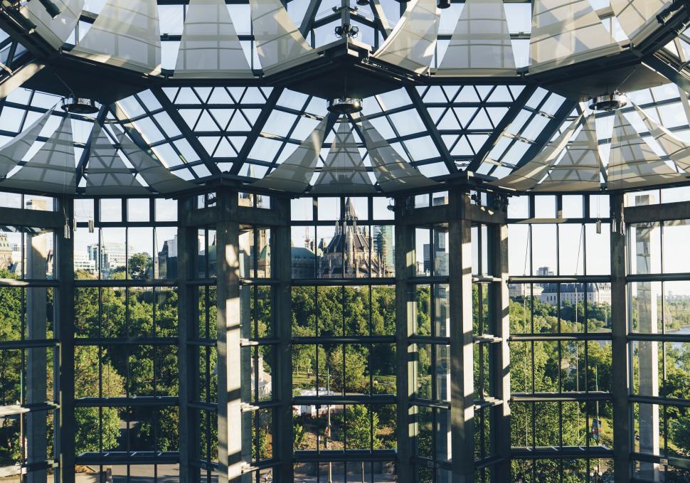 Free Image of Modern architectural glass structure with nature backdrop 