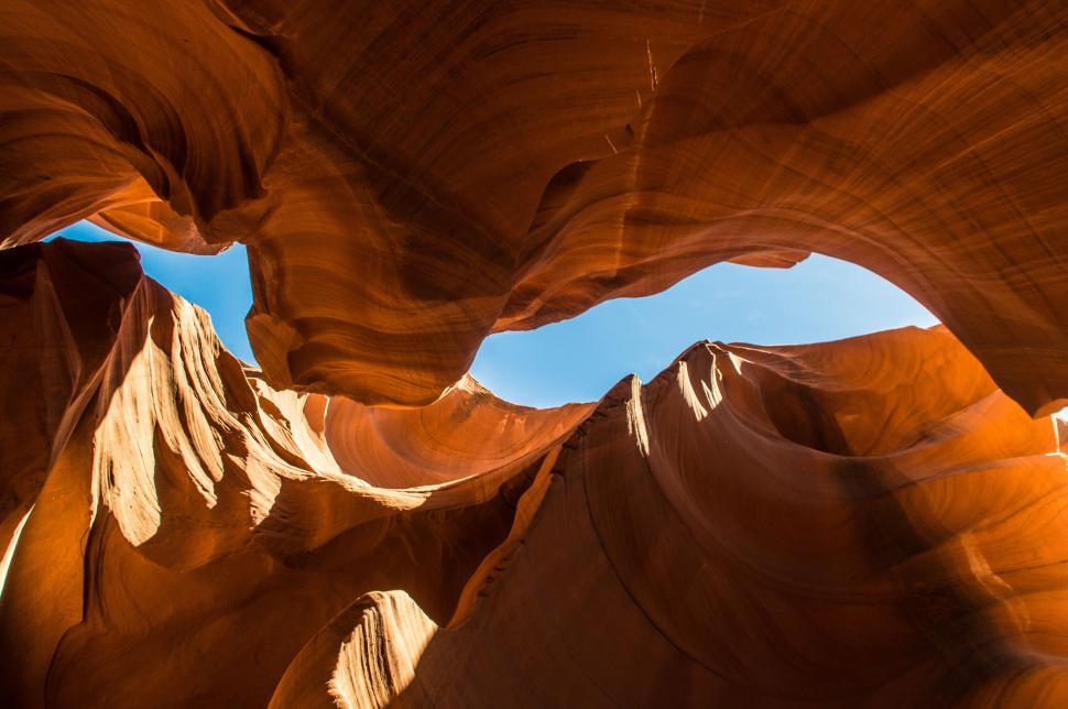 Free Image of Sunlight peeking through canyon formations in desert. 
