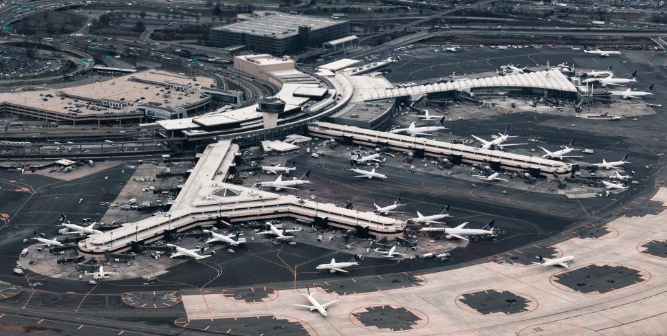 Free Image of Aerial view of a busy airport with many parked airplanes 